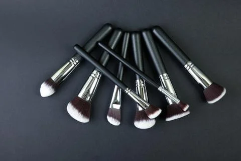 Professional makeup brushes on a black background, natural cloth Stock Photos