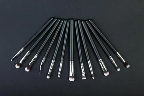 Professional makeup brushes on a black background, natural cloth Foto stock