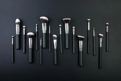 Professional makeup brushes on a black background, natural cloth Foto stock