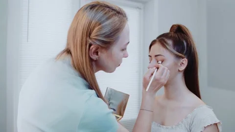 Professional makeup with a model. beautiful face of the model girl. Stock Footage 149268737