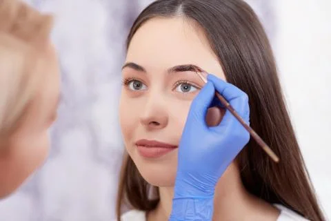 Professional making permanent eyebrows make up using brush Stock-Fotos