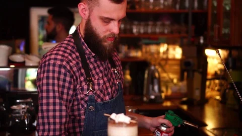 Professional male bartender performing fire sparkle tricks while preparing Stock Footage 103748115