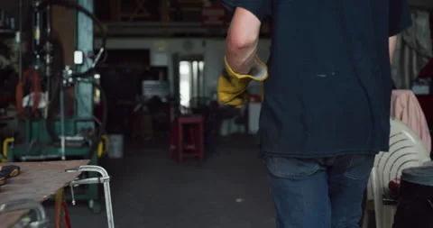 Professional male blacksmith walking into workshop and looking for a piece of me Stock Footage 199455926