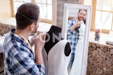 Professional male couturier perfecting design Stock Photos