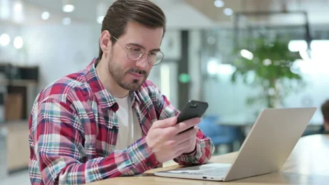Professional Male Designer using Smartphone and Laptop Video stock 139701285