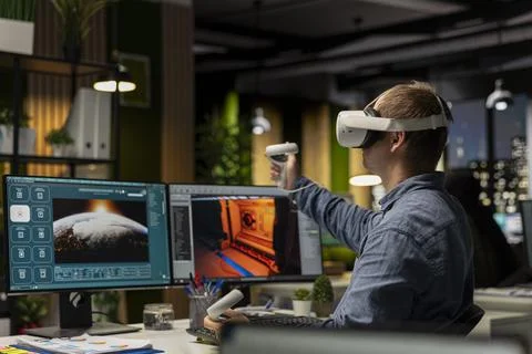 Professional male developer operating VR glasses to create spaceship station Foto stock