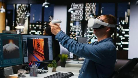 Professional male developer operating VR glasses to create spaceship station Stock Photos