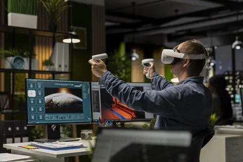 Professional male developer operating VR glasses to create spaceship station Stockfoto's