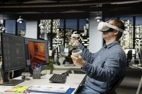 Professional male developer operating VR glasses to create spaceship station 스톡 사진