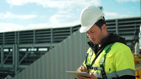 Professional male engineer during working outdoor using tablet pc medium close Stock Footage 100145619
