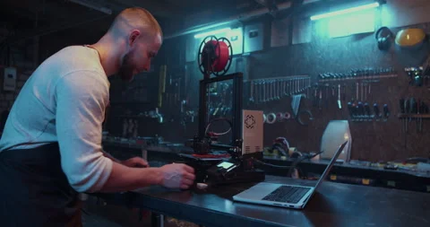 Professional male engineer using computer and 3D printer Video stock 259396010