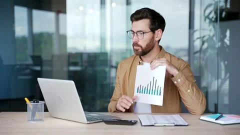 Professional male manager presenting chart data at workspace in the office.  Stock Footage 316679470