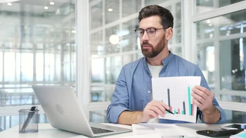 Professional male manager presenting chart data by video call using laptop while Stock Footage 326896928