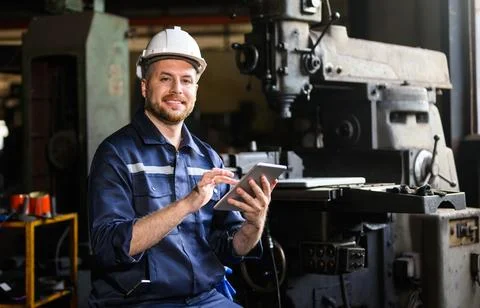 Professional male technician engineer using tablet checking machine Foto stock