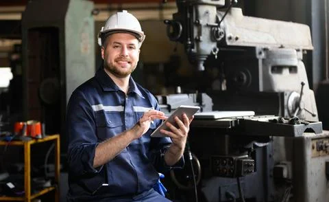 Professional male technician engineer using tablet checking machine Stock Photos
