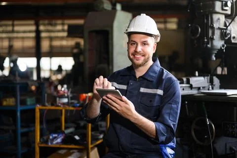 Professional male technician engineer using tablet checking machine Stock Photos
