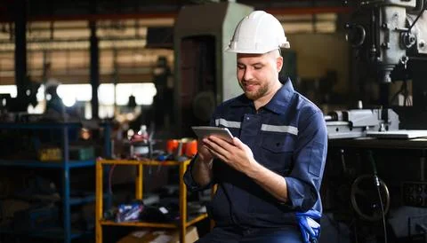 Professional male technician engineer using tablet checking machine Stock Photos