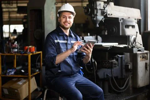 Professional male technician engineer using tablet checking machine Stock Photos