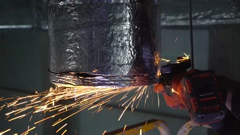 Professional male worker cutting ventilation pipe  with a grinding machine Video stock 218471061