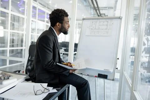 Professional man architect solving engineering problems in his workplace Stock Photos