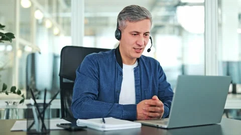 Professional Man Communicating Online with Headset in Office 스톡 동영상 318944202