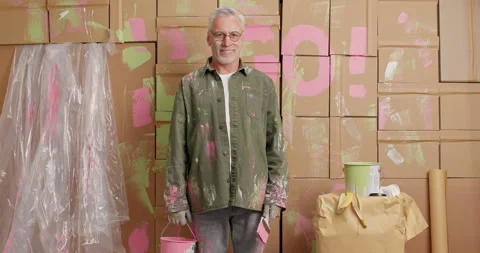 Professional man construction worker paints walls of house and thinks about Stock Footage 144920638