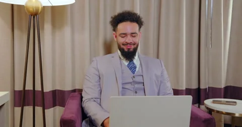A Professional Man is Engaged in Work on His Laptop within a Contemporary Office Stock Footage 293913215