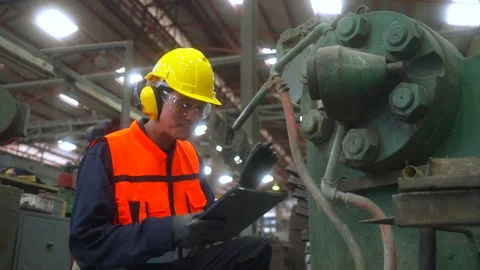 Professional man engineer analyzing meeting with tablet in factory warehouse. Stockbeeldmateriaal 332119441