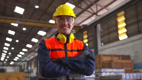 Professional man engineer wearing safety helmet in factory warehouse. Stock Footage 332119425