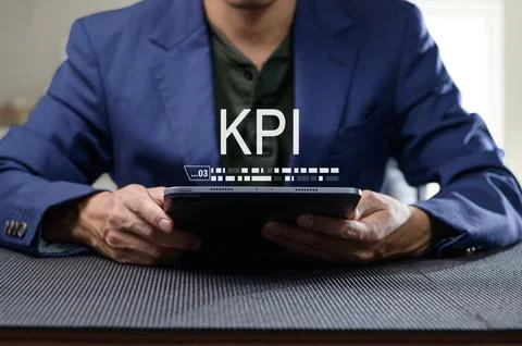 Professional Man Evaluating KPI Performance Indicators on Tablet Stock Photos