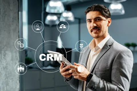 Professional man explains CRM concepts in a modern office setting with tech Stock Photos