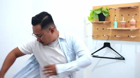 Professional Man getting ready for work hurriedly dressing in living room Stock Footage 328339485