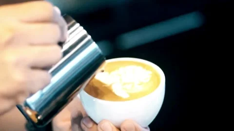 Professional man hand pouring stream milk for making espresso latte art. Stock Footage 334649823