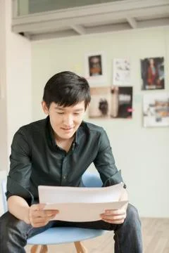 Professional Man Looking at Papers in Office Stock Photos