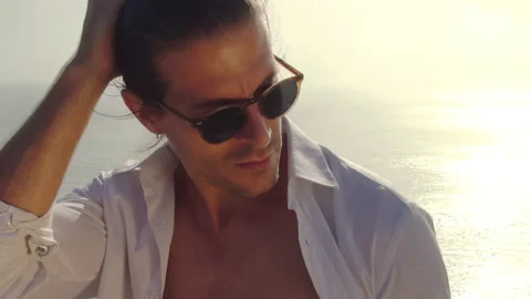 Professional man model in sunglasses on the background of the ocean  Stock Footage 168187156
