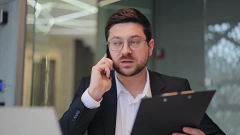 Professional Man on Phone Call in Modern Office Stock Footage 330155923