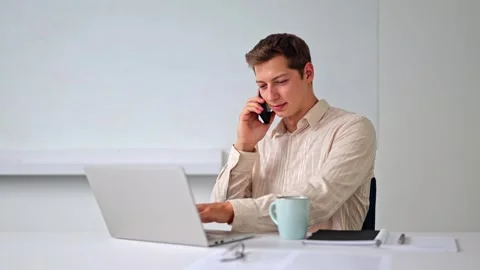 Professional Man on Phone Using Laptop 스톡 동영상 316332445