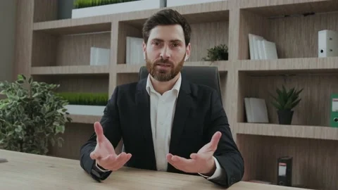 Professional man talking and looking directly into camera. Serious but friendly Stock Footage 196126900
