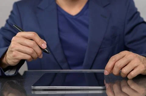 Professional Man Using Digital Tablet for Creative Work in Office Stock Photos