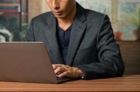 Professional Man Using Laptop in Modern Office Environment Stock Photos
