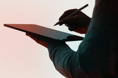 Professional man using modern touchpad computer with electronic pen for digit 库存照片