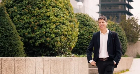 Professional man walking through a modern urban park Stock-Footage 297708588