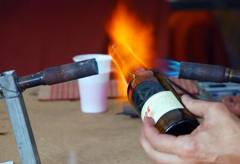 Professional man working a bottle with fire Stock Photos