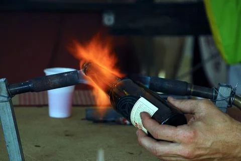 Professional man working a bottle with fire 스톡 사진