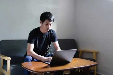 Professional Man Working on Laptop with Network Security Concept 写真素材