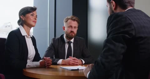 Professional manager explaining contract terms and options to clients before Stock Footage 335245552