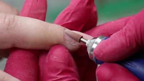 Professional of Manicure Cures the Fingers of the Client By Apparatus Stock Footage 130476247