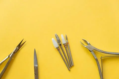 Professional manicure tools on yellow background. Manicure set. Stock Photos