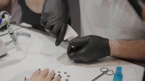 Professional manicurist man pulls out tools for manicure before the procedure. 库存影片 111323581