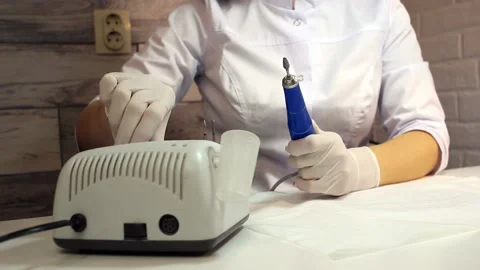 Professional manicurist switch on nail drill in nail beauty salon Stock Footage 170122841